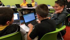 Students in a blended learning class in W.R. Thomas Middle School, in the Miami-Dade County Public School system, work on a math problem.