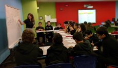 Teacher Grisel Mesa works with a small group of students in a blended learning classroom at W.R. Thomas Middle School.