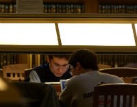 two students at library desk